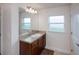 Clean bathroom offers a granite countertop vanity, decorative mirror, and warm-toned cabinets for an inviting space at 591 San Ambrosio St, Punta Gorda, FL 33983