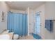 Bright bathroom featuring tile flooring, a bathtub with shower, and access to the outdoors for convenience and relaxation at 591 San Ambrosio St, Punta Gorda, FL 33983