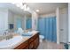 Functional bathroom with a double sink vanity, neutral tile flooring, and bright lighting creating a practical space at 591 San Ambrosio St, Punta Gorda, FL 33983