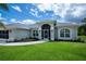 Attractive single-story home showcasing a modern design, manicured landscaping, and a welcoming entryway at 591 San Ambrosio St, Punta Gorda, FL 33983