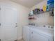 Convenient laundry room with modern washer, dryer, and ample shelving at 591 San Ambrosio St, Punta Gorda, FL 33983