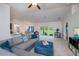 Bright living room with a comfortable gray sectional, neutral carpet, and sliding glass doors to the outdoor lanai at 591 San Ambrosio St, Punta Gorda, FL 33983