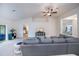 Spacious living room showcasing neutral colors, a ceiling fan, and views into the dining and bed rooms at 591 San Ambrosio St, Punta Gorda, FL 33983