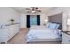 Bright main bedroom boasts a large bed, soft carpet, a ceiling fan, and bedside tables, creating a peaceful retreat at 591 San Ambrosio St, Punta Gorda, FL 33983