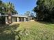 Large backyard with a spacious screened-in patio, perfect for outdoor living and entertaining at 726 Chevy Chase St, Port Charlotte, FL 33948
