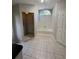 Full bathroom featuring tiled shower, separate bathtub, window, and tile flooring at 726 Chevy Chase St, Port Charlotte, FL 33948