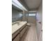 A well-lit bathroom features a large mirror, countertop, and shower-tub combo at 726 Chevy Chase St, Port Charlotte, FL 33948
