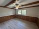This bedroom features wood-style flooring, a large window, and traditional ceiling fan at 726 Chevy Chase St, Port Charlotte, FL 33948
