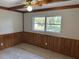 This bedroom features wood-style flooring, a large window, and traditional ceiling fan at 726 Chevy Chase St, Port Charlotte, FL 33948