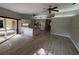 The living room opens to kitchen with white cabinets, recessed lights and stainless steel appliances at 726 Chevy Chase St, Port Charlotte, FL 33948