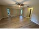 Bright main bedroom with new laminate flooring, ceiling fan, and windows allowing natural light at 726 Chevy Chase St, Port Charlotte, FL 33948