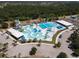 Aerial view showcases an outdoor community waterpark, featuring swimming pools, water slides, and leisure zones at 7280 Muncey Rd, North Port, FL 34291