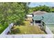 Aerial view of a large backyard with a screened porch, shed, and mature trees at 7280 Muncey Rd, North Port, FL 34291