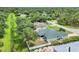 An aerial view of the neighborhood, property, and the surrounding lush greenery at 7280 Muncey Rd, North Port, FL 34291