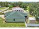 An overhead view showcases the house, shed, fenced-in yard, and its green roof at 7280 Muncey Rd, North Port, FL 34291