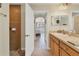 Bathroom featuring a single sink vanity, tiled shower, and view into the main bedroom at 7280 Muncey Rd, North Port, FL 34291