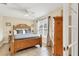 Bright bedroom featuring a wooden bed frame, tile floors, and natural light from the window at 7280 Muncey Rd, North Port, FL 34291