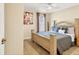 Bright bedroom features warm paint, a decorative headboard and tile floor at 7280 Muncey Rd, North Port, FL 34291