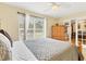 Bright bedroom featuring neutral colors and tile flooring, with an adjacent sunroom at 7280 Muncey Rd, North Port, FL 34291