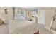 Comfortable bedroom with tile floors, ceiling fan, TV, and a large window with white blinds and curtains at 7280 Muncey Rd, North Port, FL 34291