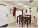 Well-lit dining room with a ceiling fan, tile floors, and a dining table with seating for four at 7280 Muncey Rd, North Port, FL 34291
