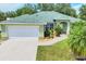Charming one-story home with a well-manicured lawn and lush landscaping in a peaceful neighborhood at 7280 Muncey Rd, North Port, FL 34291
