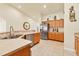 Spacious kitchen featuring oak cabinets, a stainless steel refrigerator, and tile floors at 7280 Muncey Rd, North Port, FL 34291