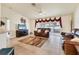 An airy living room showcasing neutral tile flooring, comfortable seating, and sliding glass doors for ample natural light at 7280 Muncey Rd, North Port, FL 34291