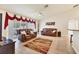 Bright living room with tile floors, two leather sofas, and sliding glass doors to the outside patio at 7280 Muncey Rd, North Port, FL 34291