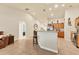Bright living space featuring tile floors, oak cabinets and island, with views to a bedroom at 7280 Muncey Rd, North Port, FL 34291