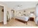 Spacious main bedroom featuring neutral decor, tile floors, ceiling fan, and mirrors for added elegance at 7280 Muncey Rd, North Port, FL 34291
