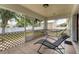Relaxing screened-in patio with tiled floor, lounge chair, and a view of the backyard at 7280 Muncey Rd, North Port, FL 34291