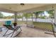 Relaxing screened-in patio with tiled floor, rocking chair, and a view of the backyard at 7280 Muncey Rd, North Port, FL 34291