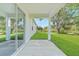 Back porch in a home overlooking a lush green yard and big trees at 7345 Ellis Ln, Port Charlotte, FL 33981
