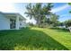 Spacious backyard with lush green grass, perfect for outdoor activities and relaxation at 7345 Ellis Ln, Port Charlotte, FL 33981