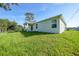 View of the house with a well-maintained lawn and landscaping at 7345 Ellis Ln, Port Charlotte, FL 33981