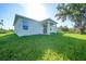 Lush green backyard with covered patio, ideal for outdoor living at 7345 Ellis Ln, Port Charlotte, FL 33981