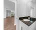 Modern bathroom vanity with black granite countertop and stainless steel fixtures at 7345 Ellis Ln, Port Charlotte, FL 33981