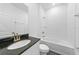 Bright bathroom with white subway tile, dark countertop, and sleek fixtures at 7345 Ellis Ln, Port Charlotte, FL 33981