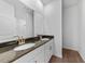 Modern bathroom featuring double sinks, granite countertops, and brass hardware at 7345 Ellis Ln, Port Charlotte, FL 33981