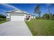 Beautiful home exterior showcasing a well-manicured lawn, modern architecture, and inviting curb appeal at 7345 Ellis Ln, Port Charlotte, FL 33981