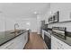 Well-lit kitchen with stainless steel appliances, granite countertops, and an open layout at 7345 Ellis Ln, Port Charlotte, FL 33981