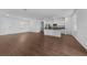 Bright living space featuring an open floorplan, wood-look floors, recessed lighting, and easy kitchen access at 7345 Ellis Ln, Port Charlotte, FL 33981