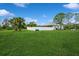 Spacious backyard with a privacy fence providing ample room for outdoor activities at 7424 Acorn Blvd, Punta Gorda, FL 33982