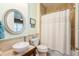 This bathroom offers a pedestal sink, modern finishes, and a shower with bathtub at 7424 Acorn Blvd, Punta Gorda, FL 33982