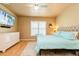 This main bedroom is well-lit with a window and features an upholstered headboard at 7424 Acorn Blvd, Punta Gorda, FL 33982