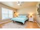 This main bedroom is well-lit with a window and features an upholstered headboard at 7424 Acorn Blvd, Punta Gorda, FL 33982