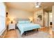 This main bedroom is well-lit with a window and features an upholstered headboard at 7424 Acorn Blvd, Punta Gorda, FL 33982