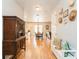 Open entryway with hardwood floors, a bench, and a view of the dining area at 7424 Acorn Blvd, Punta Gorda, FL 33982