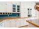 Kitchen with white cabinets and hardwood floors at 7424 Acorn Blvd, Punta Gorda, FL 33982
